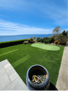 Synthetic Turf Northwest - Window reflection damage to synthetic turf in a backyard with a golf green.